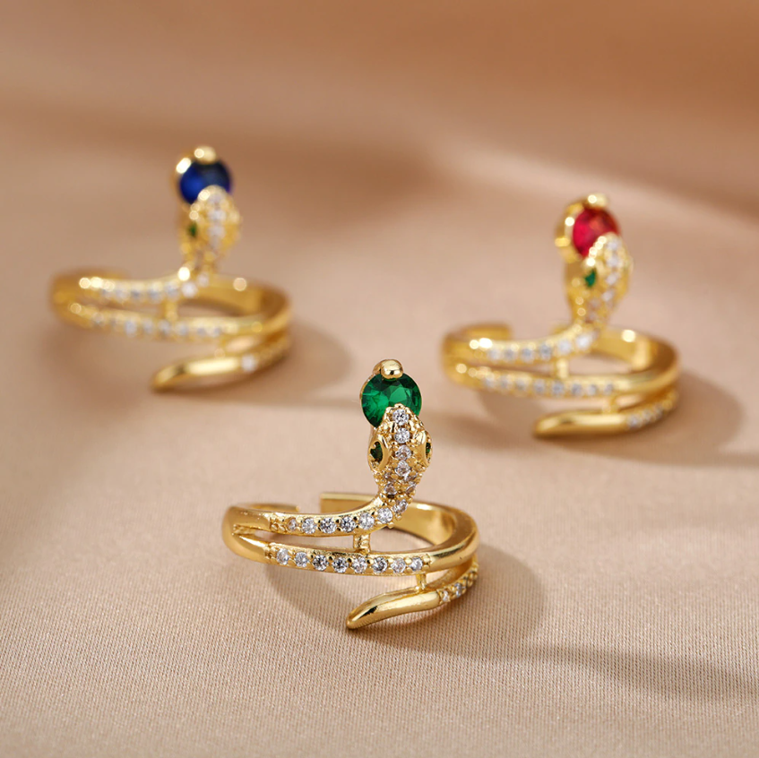 Gold Serpent Rings Holding Sparkling Gemstones