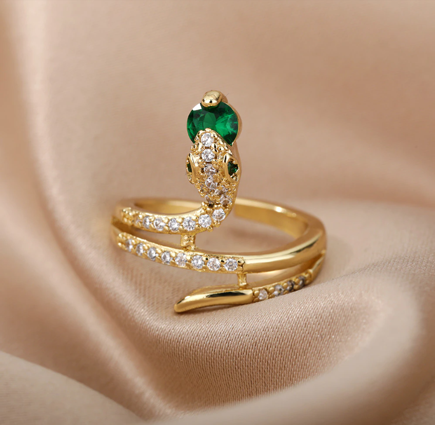 Gold Serpent Rings Holding Sparkling Gemstones