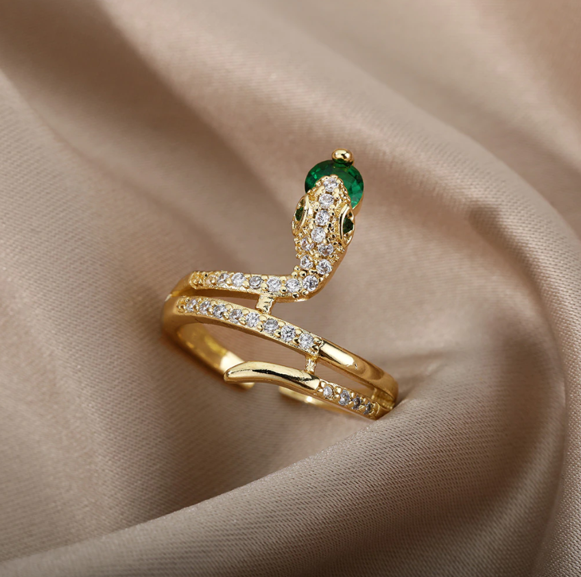 Gold Serpent Rings Holding Sparkling Gemstones