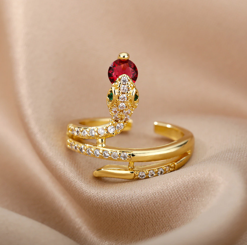 Gold Serpent Rings Holding Sparkling Gemstones