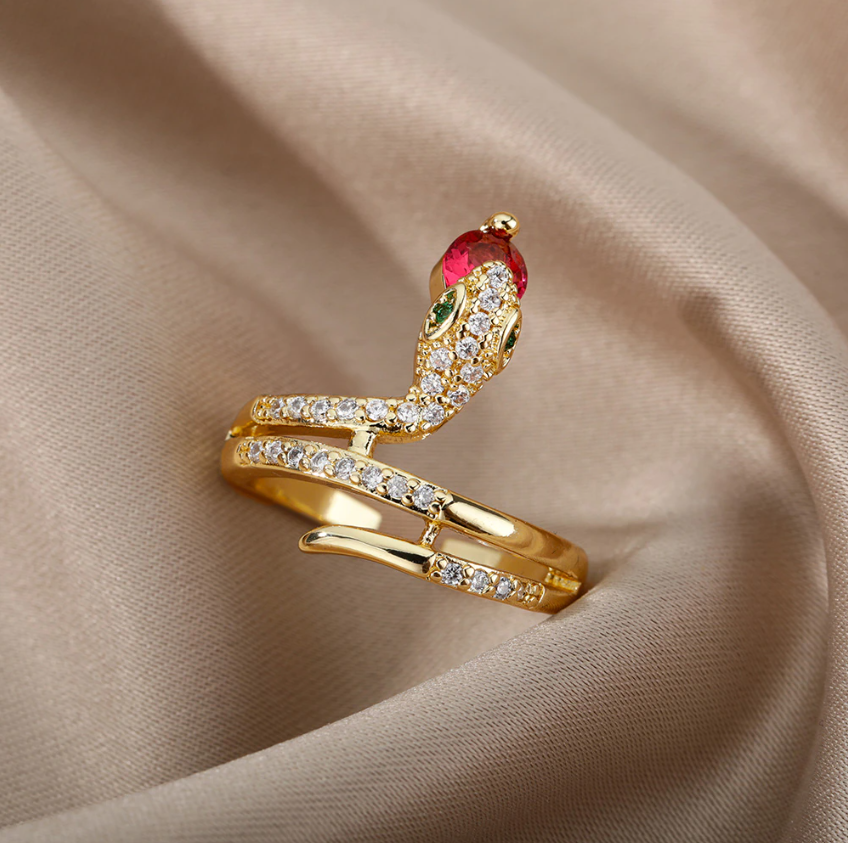 Gold Serpent Rings Holding Sparkling Gemstones