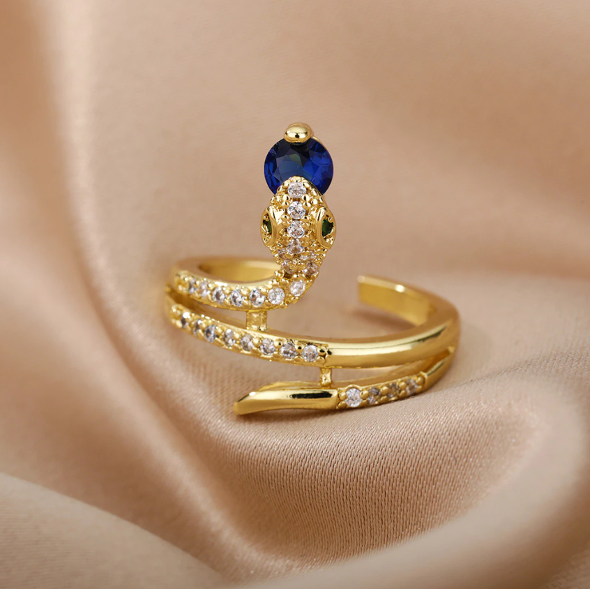 Gold Serpent Rings Holding Sparkling Gemstones